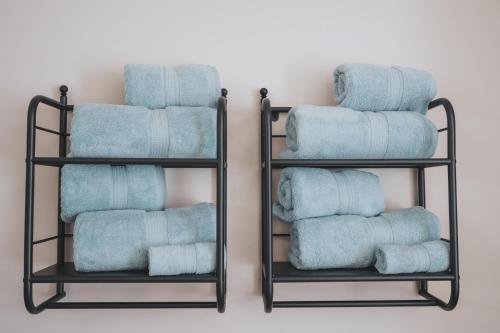 two shelves filled with towels in a bathroom at The Tides, 3 bed house Morecambe in Morecambe