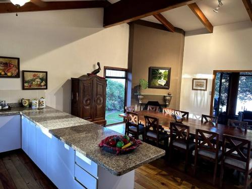 a kitchen and dining room with a counter and a table at Beautiful Lake Front House AT001 in Sololá