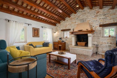 a living room with couches and a brick wall at Villa Lipa in Krnica