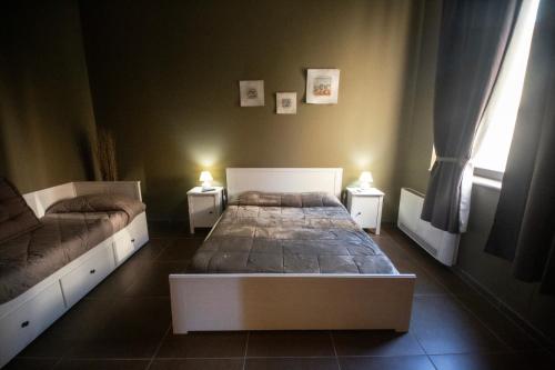 a bedroom with a bed and two night stands at Dimora Nettare in Brindisi