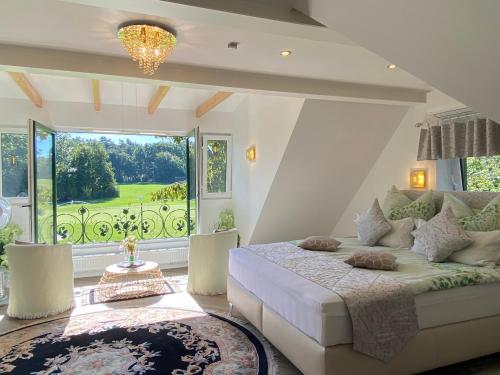 a bedroom with a bed and a large window at Romantic Greenhouse in Syke