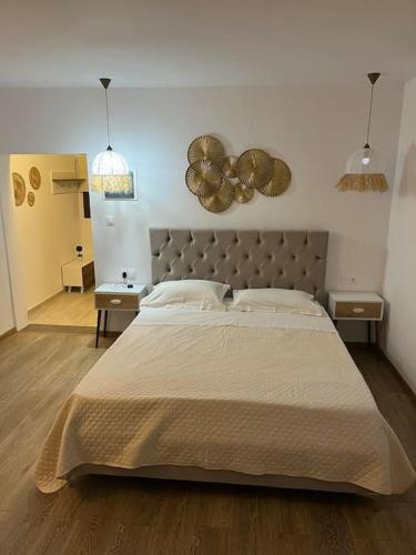 a bedroom with a large bed and two night stands at Το σπίτι του Σταμάτη in Skiathos Town