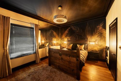 a bedroom with a large bed with a black wall at Casa Amor - Adult Only Retreat Midlands in Stoke on Trent