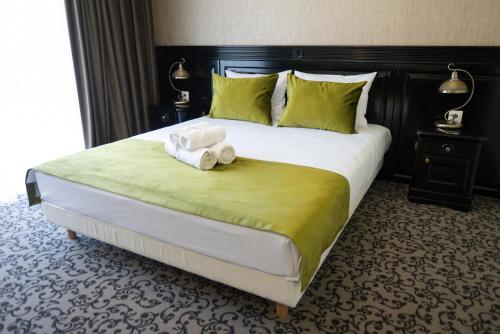 a bedroom with a large bed with towels on it at Casa del Monte - Dorna Arini in Dorna Arini