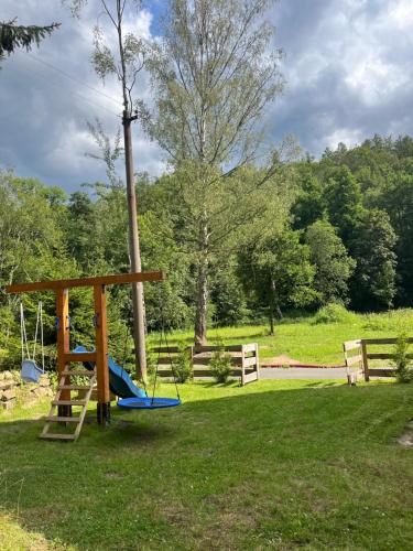 a playground in a park with a swing at Chalupa Krásný Buk, České Švýcarsko in Krásná Lípa