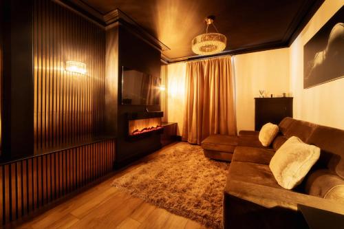 a living room with a couch and a fireplace at Casa Amor - Adult Only Retreat Midlands in Stoke on Trent