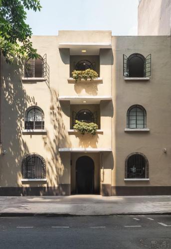 a building with flower boxes on the side of it at Second Home Tamesis in Mexico City