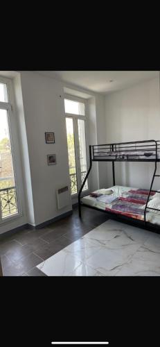 a bedroom with two bunk beds and a window at Hotel Rex in Marseille