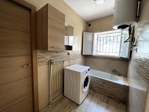 a bathroom with a washing machine and a sink at La Casita Gergaleña, Confort in Gérgal