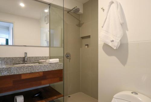 a bathroom with a shower with a toilet and a sink at Monumental by Wynwood House in Lima