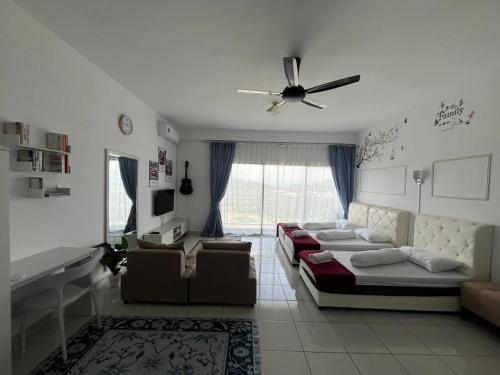 a living room with a bed and a couch at Camelia youth city nilai studio residence 5 pax. in Nilai