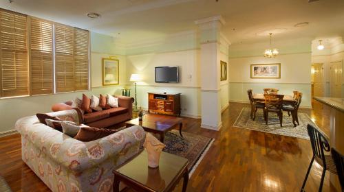 a living room with a couch and a table at Royal Albert Hotel in Brisbane
