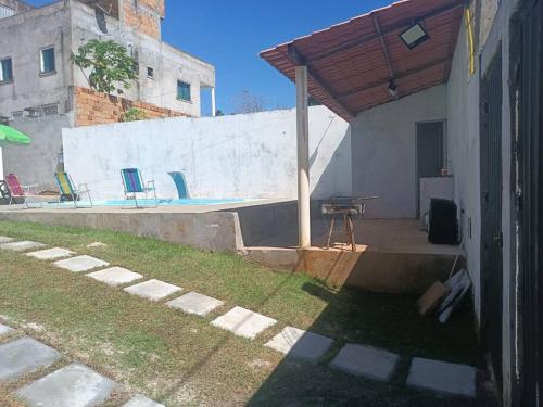 a patio with a picnic table and a pavilion at Casa com piscina in Camacari