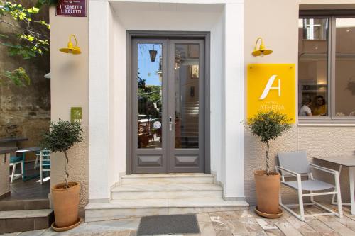 a door to a restaurant with chairs and a table at Athena hotel in Nafplio