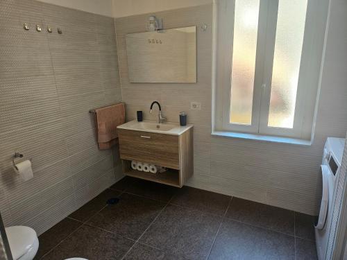 a bathroom with a sink and a mirror at La Dolce Vita Apartments Amalfi in Salerno