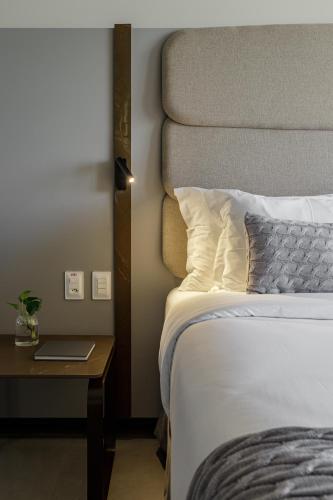 a hotel room with a bed and a table with a laptop at HCM - Hotel Corais de Manaira in João Pessoa