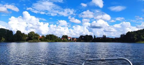 a boat on a lake with clouds in the sky at Erholen am See in Lychen