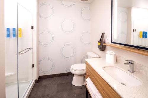 a bathroom with a toilet and a sink and a shower at Tru By Hilton Yakima Airport in Yakima