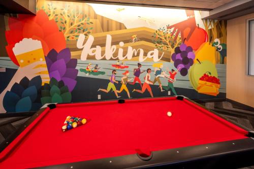 a pool table in a room with a mural at Tru By Hilton Yakima Airport in Yakima