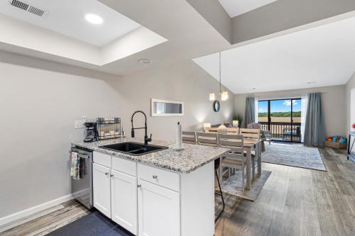 a kitchen and dining room with a table and chairs at Table Rock Retreat in Kimberling City