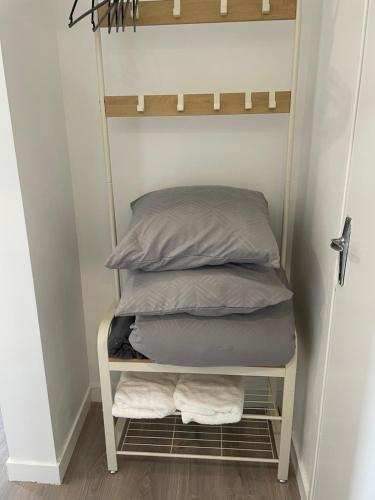 a stack of pillows on a shelf in a room at Appart 4 personnes 1 ch Laval in Laval