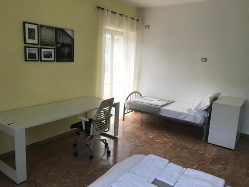 a room with a desk and a bed and a desk and chair at Forconium in LʼAquila