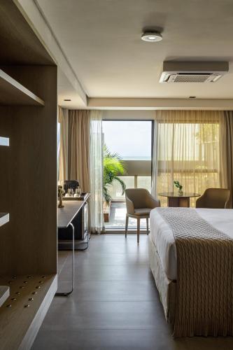a hotel room with a bed and a desk at HCM - Hotel Corais de Manaira in João Pessoa
