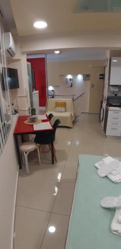 a kitchen and living room with a table and a couch at P & M Studio in Kavala