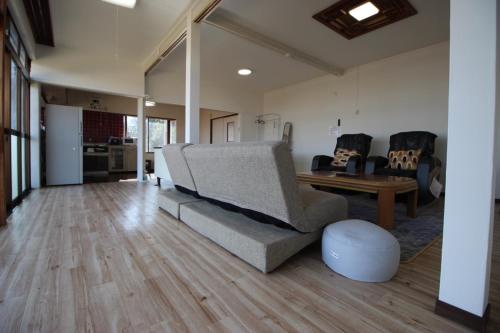 a living room with a couch and a table at Fukutokukashiya - Vacation STAY 16907 in Kagoshima