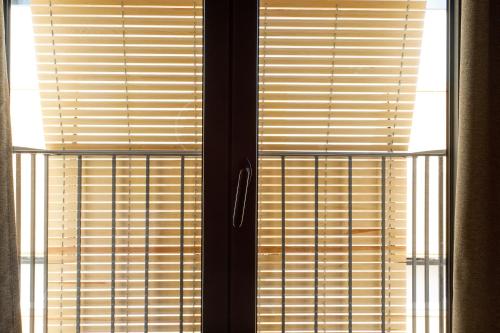a window with the blinds open in a room at Hostal Olga in Sant Antoni de Calonge