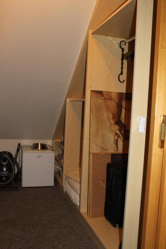 a room with a staircase with a closet with a door at Gästehaus Braunegger in Lamprechtshausen