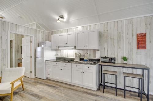 a kitchen with white cabinets and a refrigerator at Pet-Friendly Picayune Tiny Home Near Space Center! in Picayune