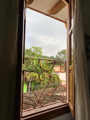 an open window with a view of a garden at Casa Miguel Arcangel in Coatepec