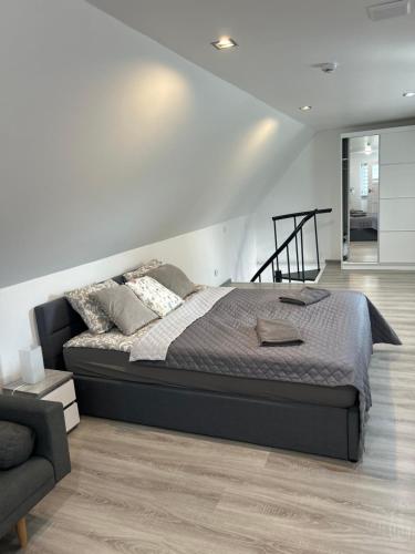 a bedroom with a large bed and a couch at Koniec Świata - Nowa Stodoła Mikolajki in Stare Sady