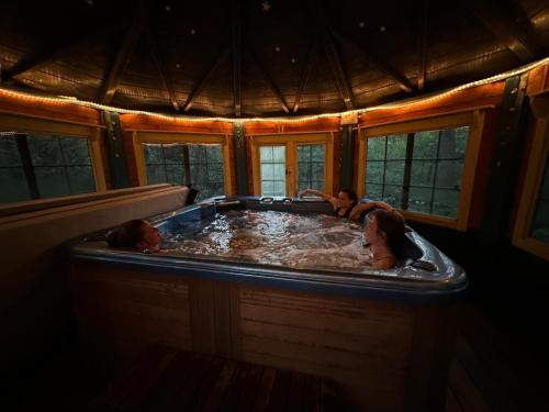 two people in a hot tub in a house at Domaine de la Jarnoise in Saint-Agnan