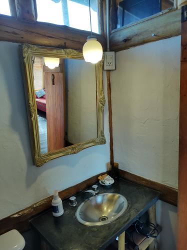 a bathroom with a sink and a mirror at Cabaña La Linda - Complejo El Taller in Potrerillos