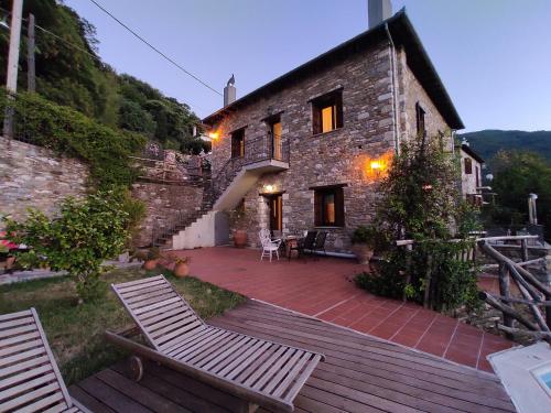 a stone house with two chairs on a patio at Miression Pelion House in Mouresi