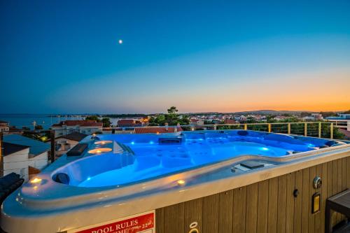 a large blue hot tub on the roof of a building at Luxury Apartments VilaMaloca in Vir
