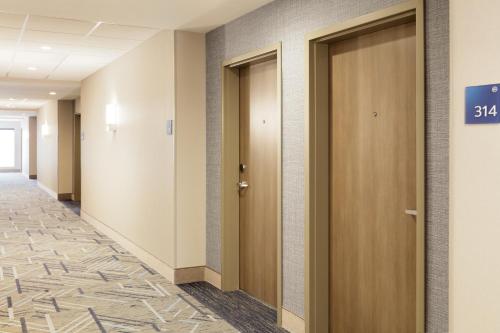 a corridor of a hospital hallway with two doors at Holiday Inn Express Williamston by IHG in Williamston