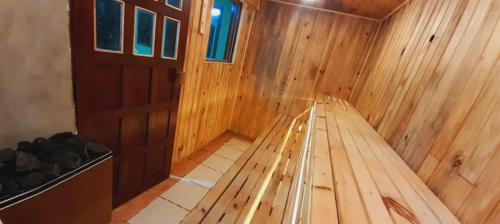 a wooden interior of a sauna with a wooden door at Hotel Pousada Viking in Jacumã
