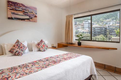 Postel nebo postele na pokoji v ubytování Hotel Eloisa