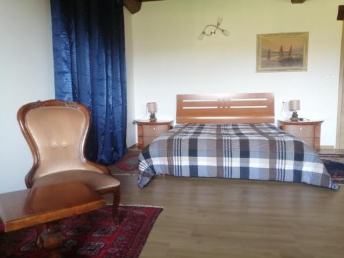 a bedroom with a bed and a chair at Silentium Domus doo in Gornje Vreme