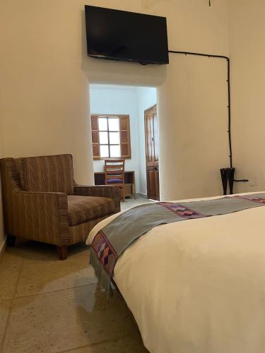 Postel nebo postele na pokoji v ubytování Hotel Casona El Calvario