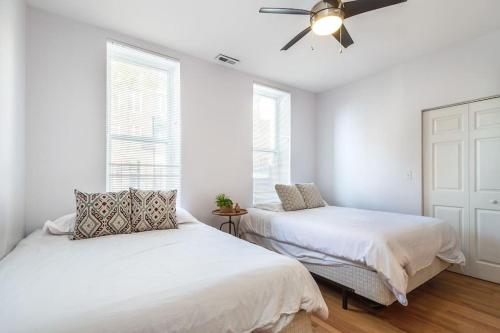 a bedroom with two beds and a ceiling fan at Lincoln Park Living - Suite 1 in Chicago