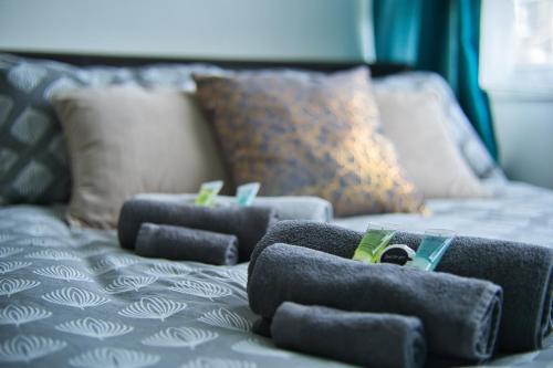 a blue bed with four pillows on it at NICE CITY DOUBLE Bedroom in London