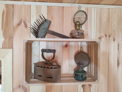 a wooden shelf with two different items on it at Rural household Konak Vukovica in Mojkovac