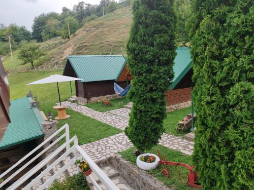 an overhead view of a yard with a house and a large tree at Rural household Konak Vukovica in Mojkovac