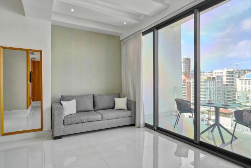a living room with a couch and a table at Monaco Residences Piantini in Santo Domingo