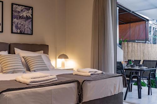 a bedroom with a bed with towels on it at Marelia Garden House in Mitikas