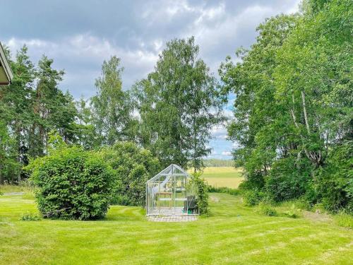 a greenhouse in the middle of a grass field at 4 star holiday home in BRO in Bro